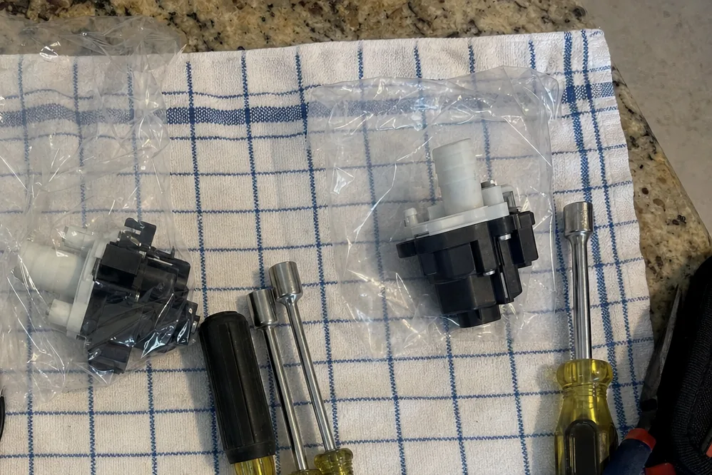 The corner of a work cloth with test leads and a small replacement part resting on it